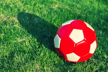 White red football ball on grass