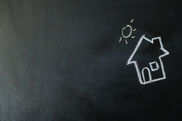 image of a house with chalk on a blackboard