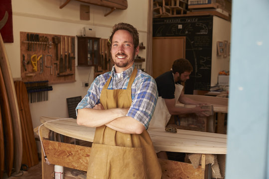 Portrait Of Carpenter Making Bespoke Surfboards In Workshop - Powered by Adobe