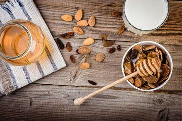 oat flakes with fresh honey, nuts and milk for breakfast, top view.