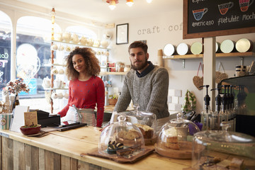Portrait of young couple standing in cafe