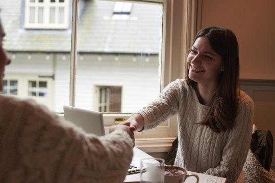Young Woman Using Laptop Having Business Meeting