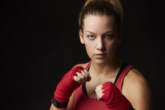 Young woman in boxing stance, head and shoulders portrait