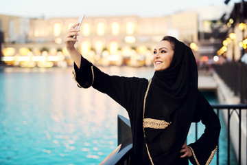 Arabian woman taking selfie.