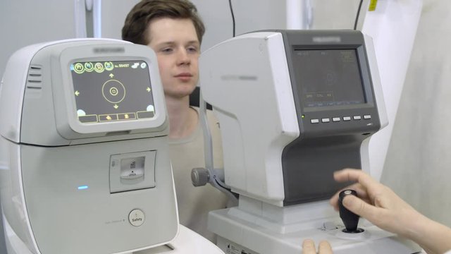 Doctor excaminating man's vision using machine