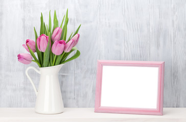 Fresh pink tulips bouquet and photo frame