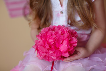 paper flower in the hands of a child