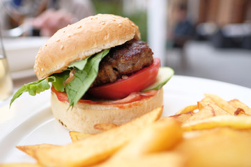 Hamburger and fries at restaurant table