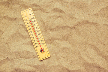 Record high temperatures, thermometer on warm desert sand