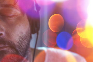 Half face portrait of adult man listening to music