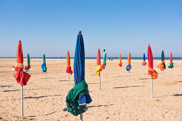 Fototapeta na wymiar The famous colorful parasols on Deauville beach