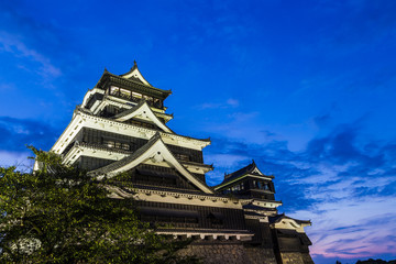 Kumamoto Castle at night in Kumamoto, Kyushu, Japan.