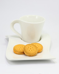 Lemon orange cream sandwich biscuit cookie on cup and saucer