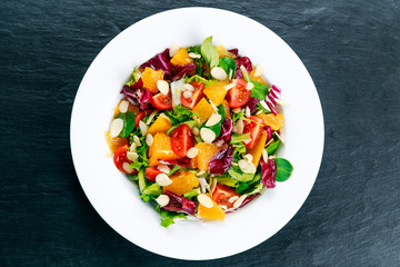 Fresh Orange, vegetables salad. on wooden table.