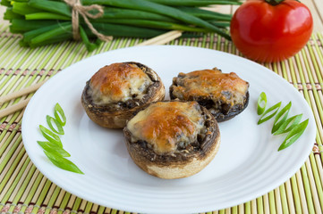 Baked stuffed mushrooms on a white plate. Vegan dish.