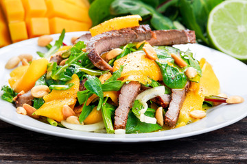 Fresh Tasty Mango, beef salad with vegetables and nuts.