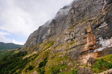 Fog in the mountains. Mountain in the clouds. Cloudy weather. Rock