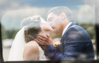 Close up portrait of kissing wedding couple