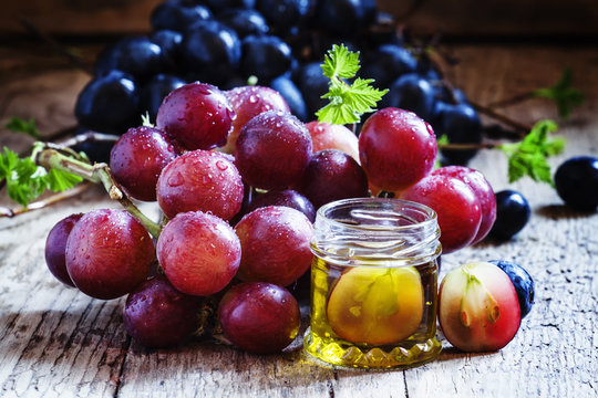 Essential oil of grape seeds and a fresh bunch of grapes, vintag