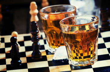 Cold brandy on a chess board, selective focus