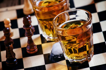 Cold brandy on a chess board, selective focus