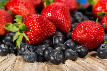 Plate full of fresh blueberries and strawberries