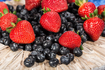 Plate full of fresh blueberries and strawberries