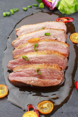 Pekin duck with vegetables over black background