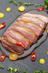 Pekin duck with vegetables over black background