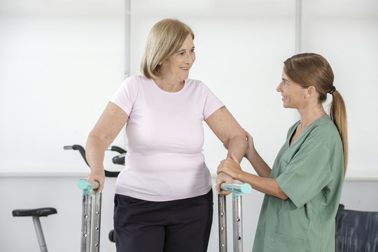 Physiotherapist helping senior woman