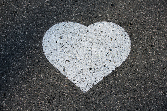 White heart shape painted on street asphalt