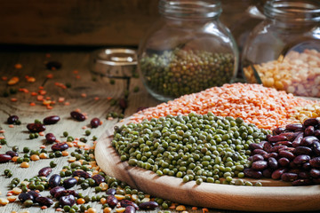 Green lentils on a vintage wooden background, mixed beans, selec