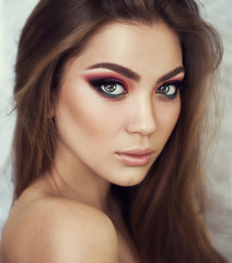 Obraz premium Sexy Beauty Girl with natural Lips and Provocative Make up on her eyes. Luxury Woman with Green Eyes. Fashion Brunette Portrait on a silver background. Gorgeous Woman Face. Long Hair