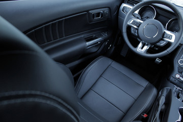 Obraz na płótnie Canvas Black leather and chrome parts in car interior 