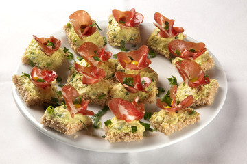 Bruschettas with prosciutto smoked meat, dried tomatoes