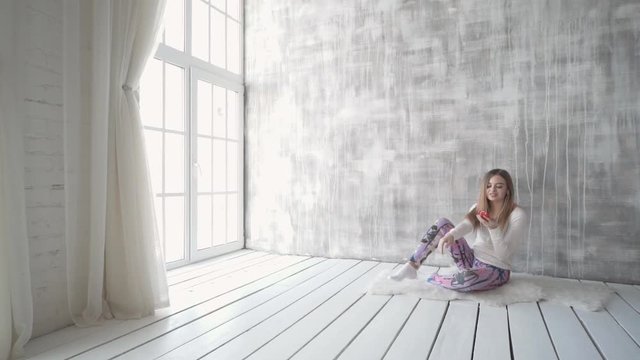 Happy teen girl listening to the music and chatting by smart phone