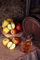 Composition of fresh apples and tasty cider on wooden table