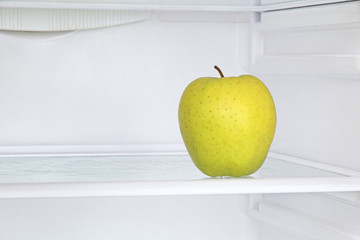 Ripe apple in domestic refrigerator taken closeup.
