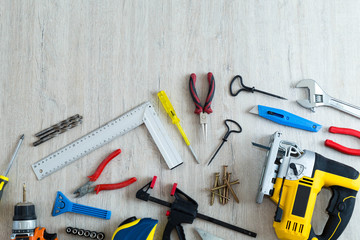 Different tools on a wooden background with the place for inscri