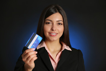 Businesswoman holding a credit card.