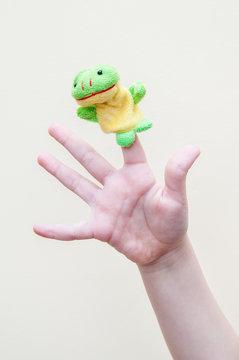 frogling made of cloth put on the index finger