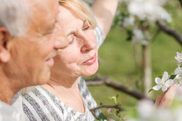 Senior couple enjoying a moment in their blossoming garden.