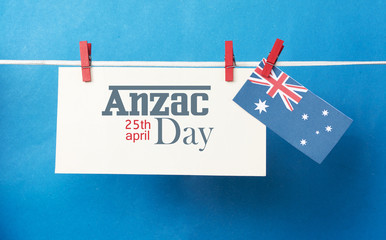 Remembrance, November 11, or Anzac Day, April 25, public holiday with pegs on a line message greeting on white Australian maps with Aussie flag. Lest We Forget, retro filters light effects.