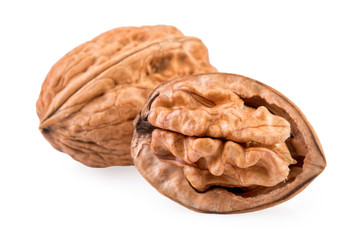 Two Walnuts whole and half in closeup.