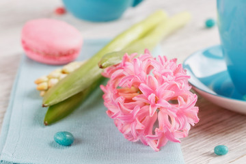 Cup of black coffee and pink flower