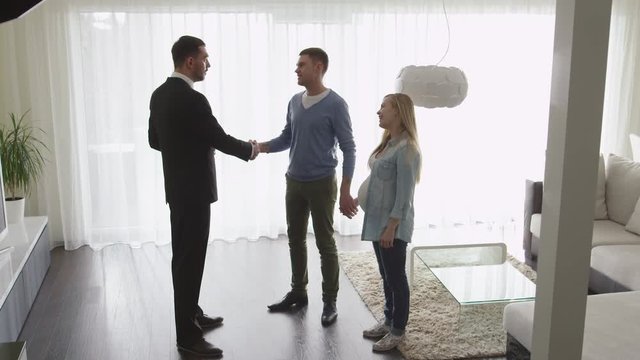 Real-estate Agent Shows New Apartments to Couple. Handshake between Agent and Man. Shot on RED Cinema Camera.