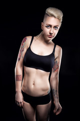 Fototapeta na wymiar punk blonde female with tattoo and piercing and short haircut;