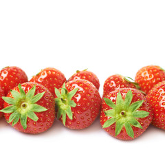 Line of red strawberries isolated