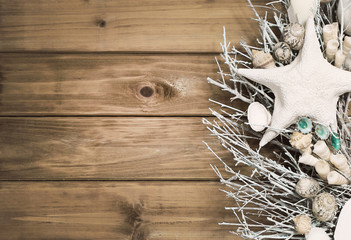 Sea shells and starfish over old wooden background