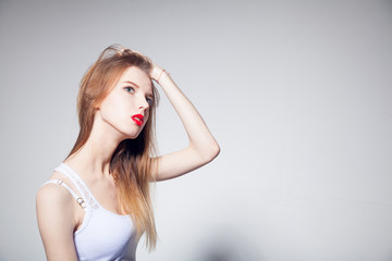 Obraz premium Sensual young woman with beautiful long brown hairs, posing isolated on white